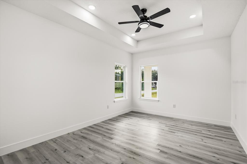 2798 Gainesville Road Southeast Palm Bay, FL 32909 - Photo 23 of 35 an empty room with wooden floor and windows