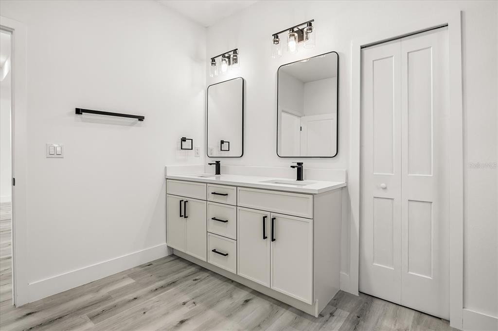 2798 Gainesville Road Southeast Palm Bay, FL 32909 - Photo 29 of 35 a bathroom with a double vanity sink mirror and