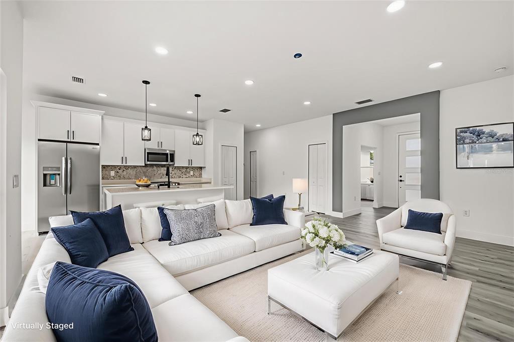 2798 Gainesville Road Southeast Palm Bay, FL 32909 - Photo 6 of 35 a living room with furniture white walls and kitchen view