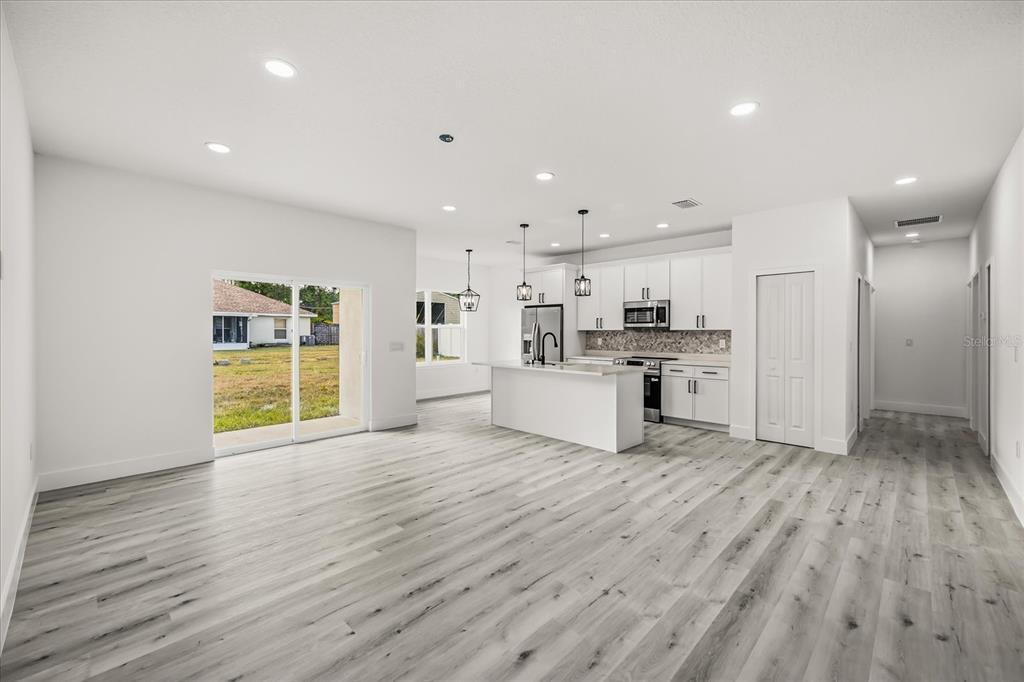 2798 Gainesville Road Southeast Palm Bay, FL 32909 - Photo 8 of 35 a view of kitchen with granite countertop cabinets and refrigerator