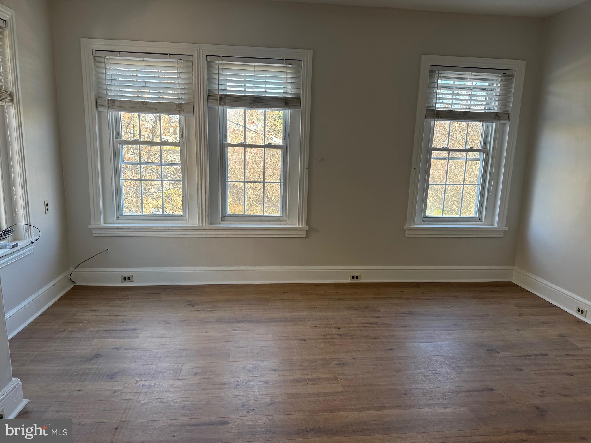 1812 Delaware Avenue, Unit 2 Wilmington, DE 19806 - Photo 3 of 13 an empty room with wooden floor and windows
