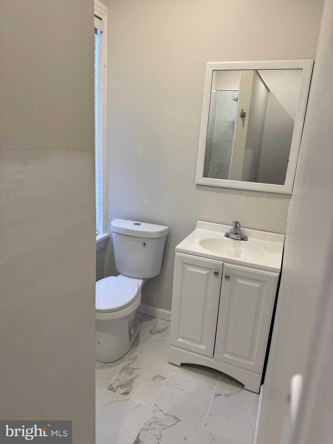 1812 Delaware Avenue, Unit 2 Wilmington, DE 19806 - Photo 10 of 13 a bathroom with a toilet sink and mirror
