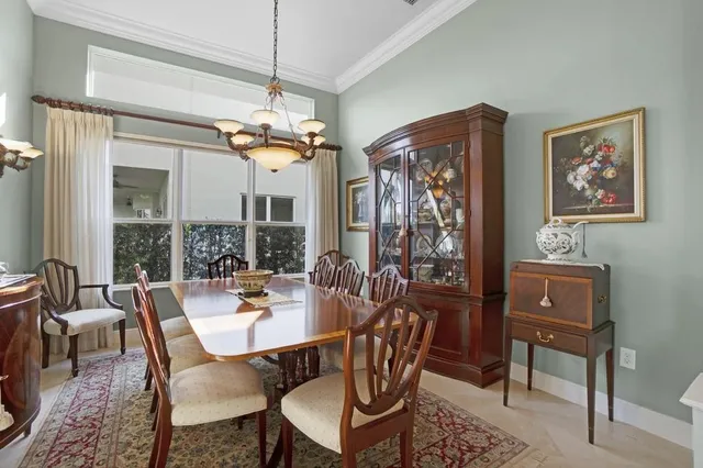 a view of a dining room with furniture a chandelier and a chandelier