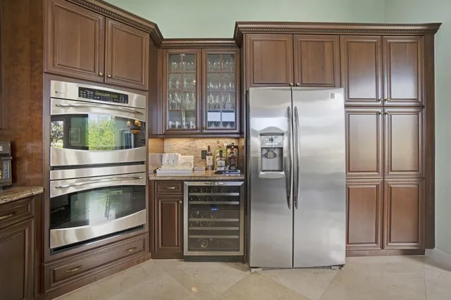 a kitchen with appliances a stove and cabinets
