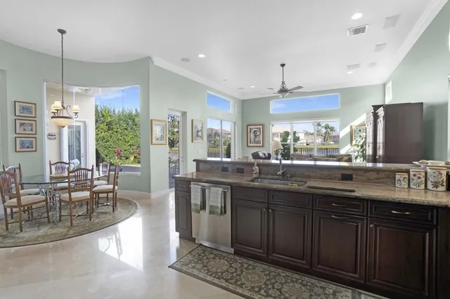 a kitchen with stainless steel appliances granite countertop a stove and cabinets