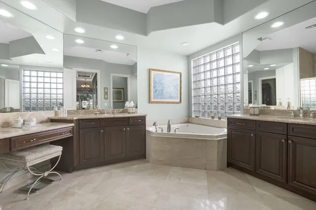 a bedroom with a bed and a lamp on dresser