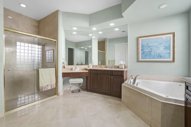 a bathroom with a granite countertop sink mirror vanity and toilet