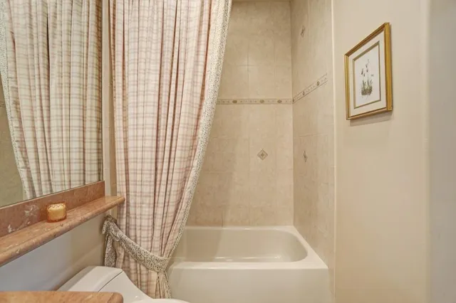 a view of a house with a yard and potted plants