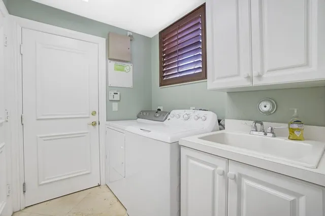 a view of a house with garden and a large tree