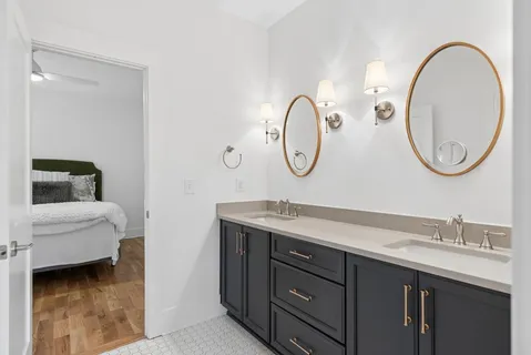 a bathroom with a toilet a sink and a mirror