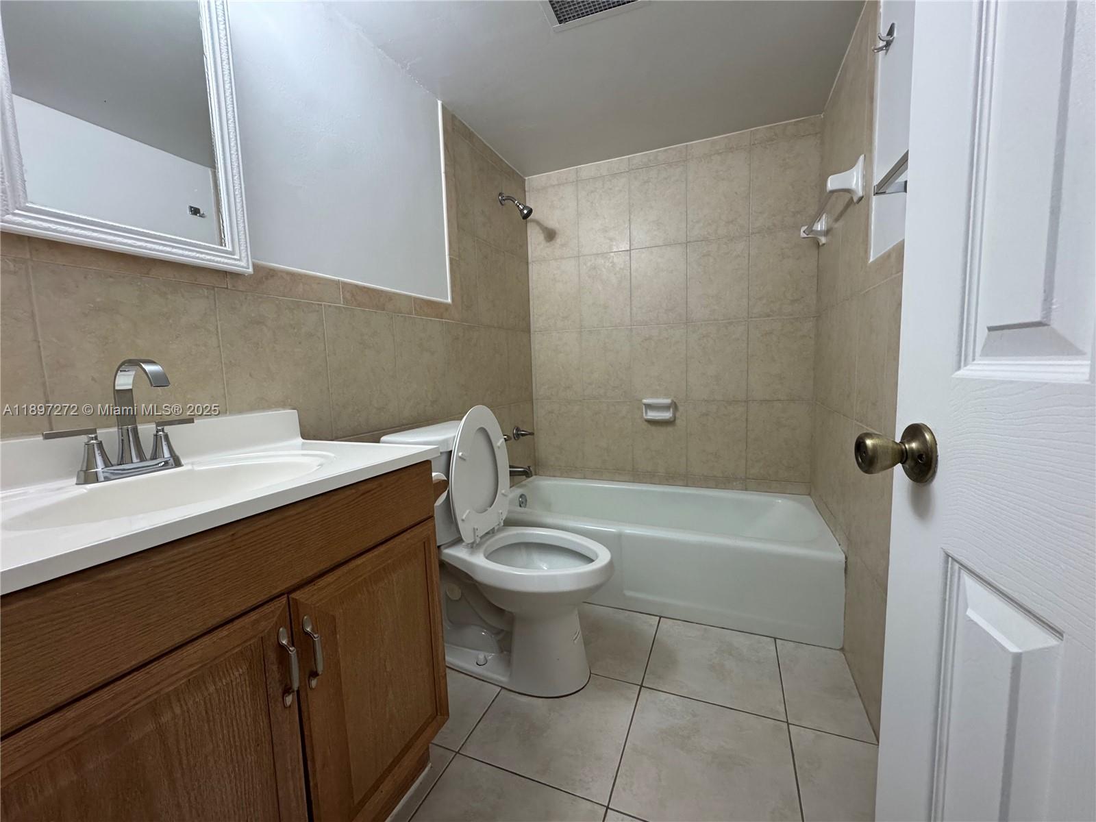 8315 Southwest 72nd Avenue, Unit 101B Miami, FL 33143 - Photo 11 of 18 a bathroom with a sink a toilet and shower