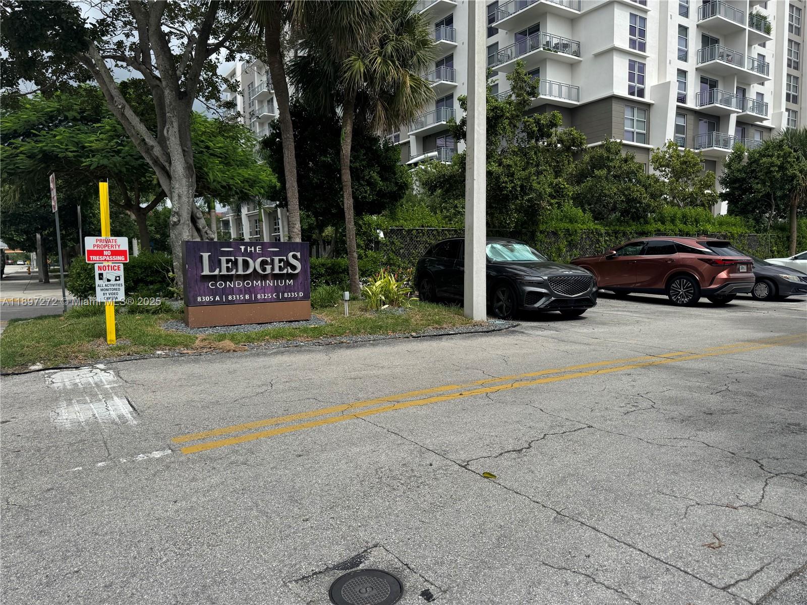 8315 Southwest 72nd Avenue, Unit 101B Miami, FL 33143 - Photo 2 of 18 a view of street with parked cars