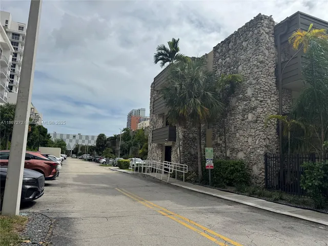 a view of a street with cars on both side of road