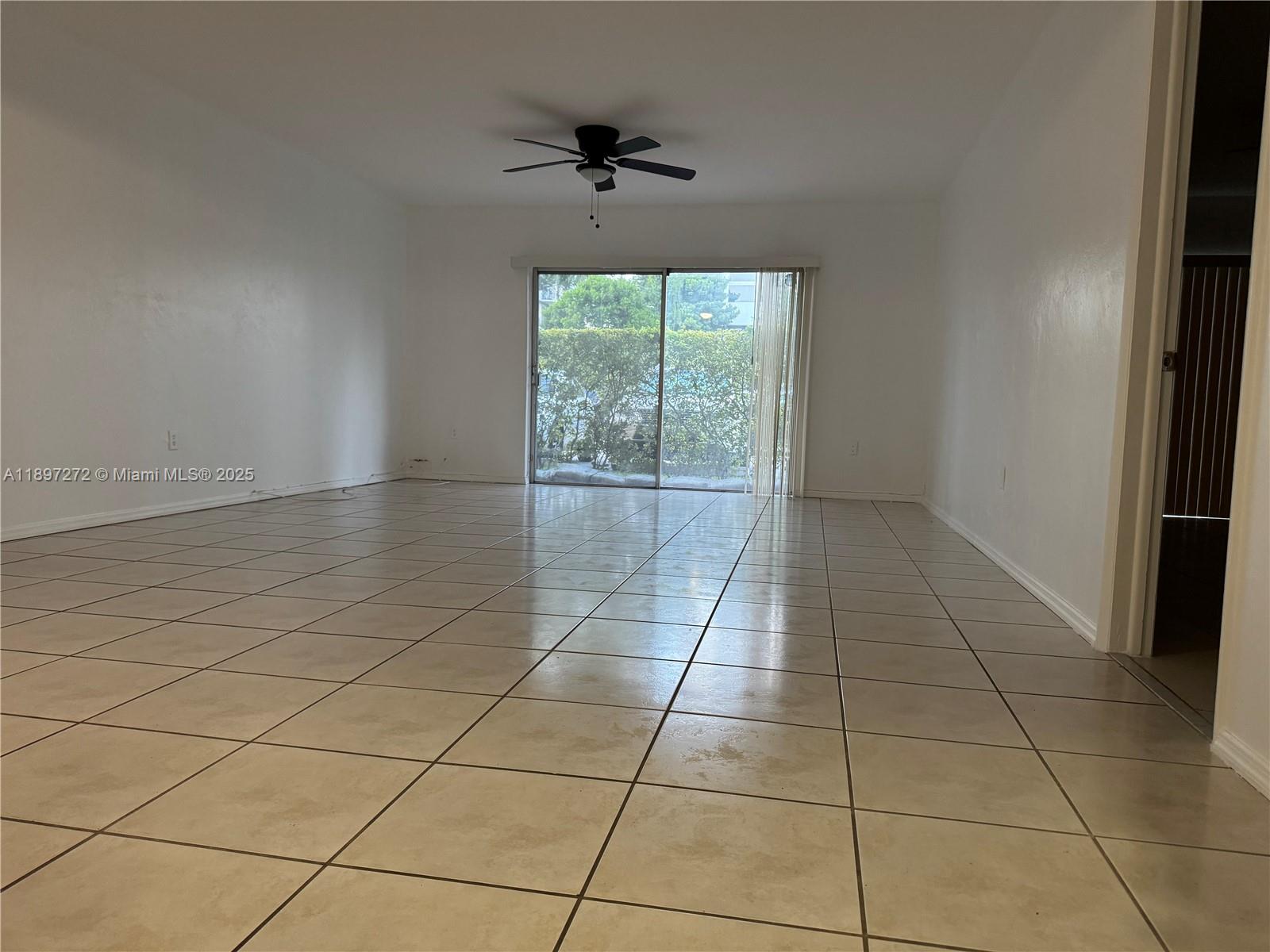 8315 Southwest 72nd Avenue, Unit 101B Miami, FL 33143 - Photo 4 of 18 a view of an empty room with a window