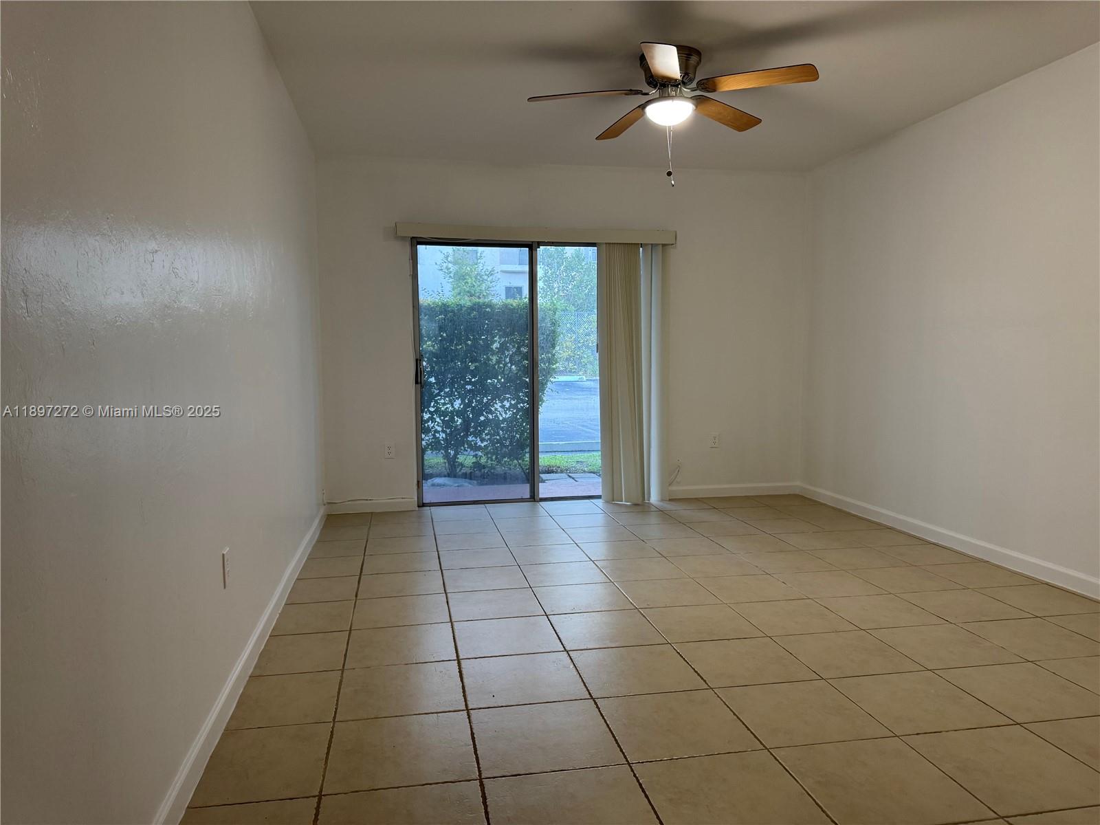 8315 Southwest 72nd Avenue, Unit 101B Miami, FL 33143 - Photo 5 of 18 an empty room with windows and fan
