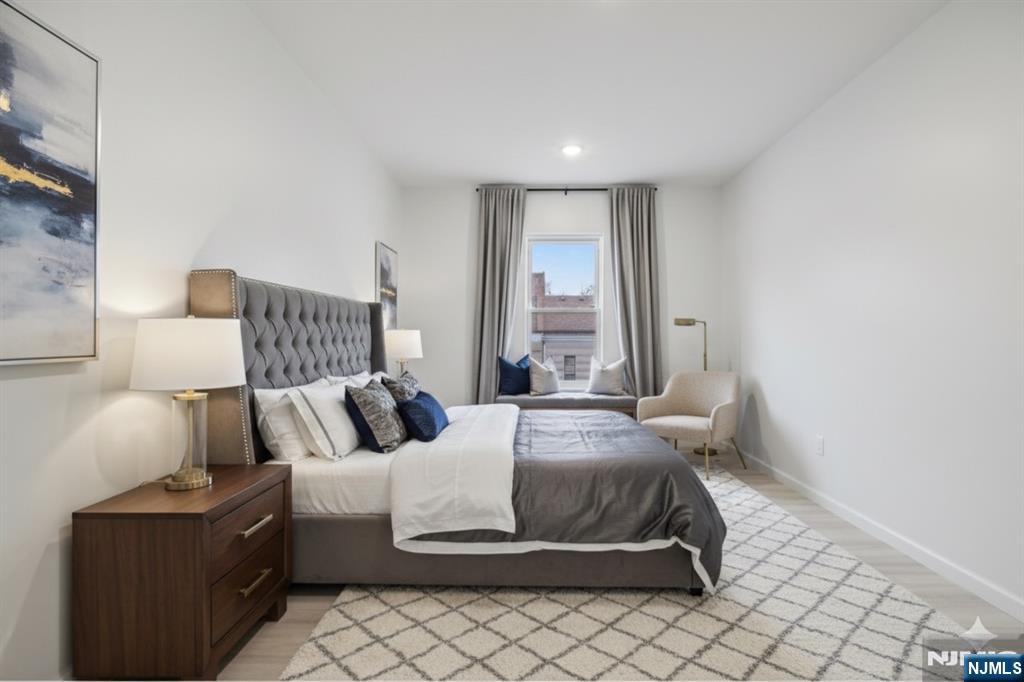 542 East 25th Street, Unit 540 Paterson, NJ 07514 - Photo 8 of 11 a bedroom with a bed and lamp