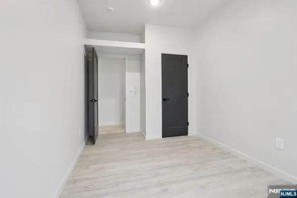 a view of a room with wooden floor