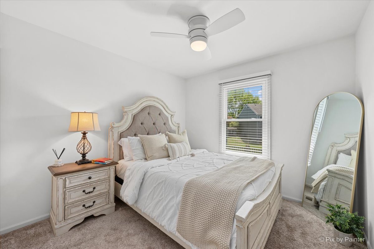 1150 Appleton Lane Geneva, IL 60134 - Photo 10 of 43 a bedroom with a bed and a chandelier