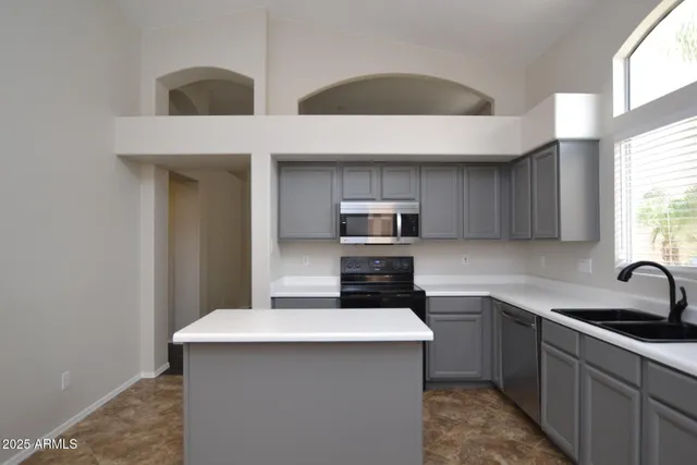 a kitchen with stainless steel appliances a sink stove and refrigerator