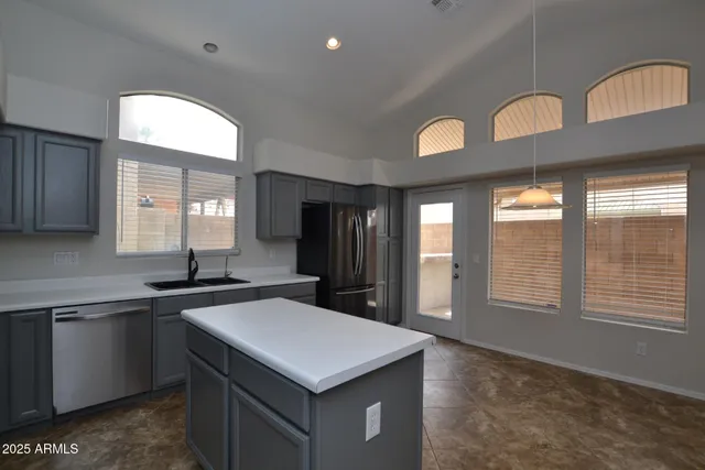 a kitchen with a sink a counter top space and a window