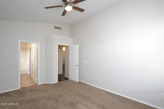 a view of a hallway with a chandelier fan