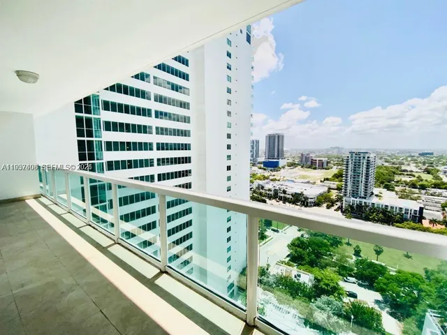 a view of a balcony with a floor to ceiling window and wooden fence