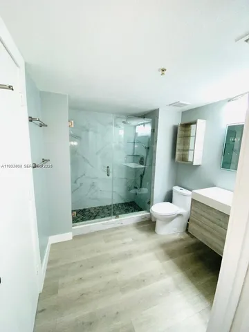 a bathroom with a shower and a toilet