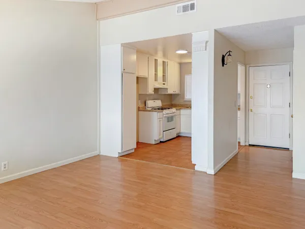 a view of a kitchen with a stove top oven and cabinets