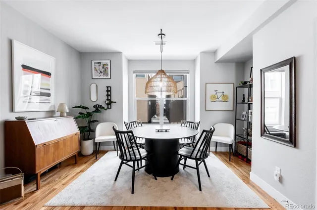a view of a dining room with furniture window and wooden floor