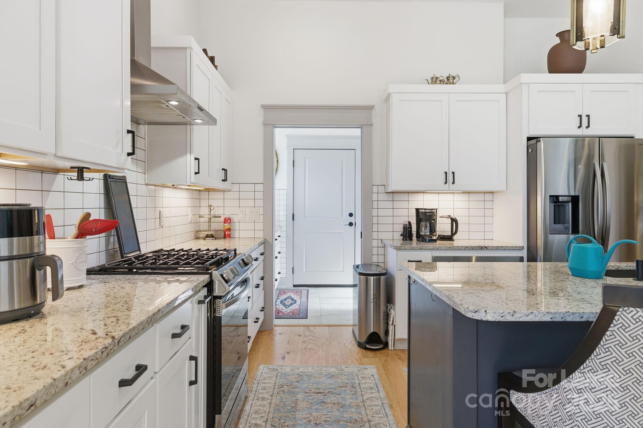 46 Cozy Cottage Way Arden, NC 28704 - Photo 12 of 37 a kitchen with stainless steel appliances granite countertop a sink stove and refrigerator