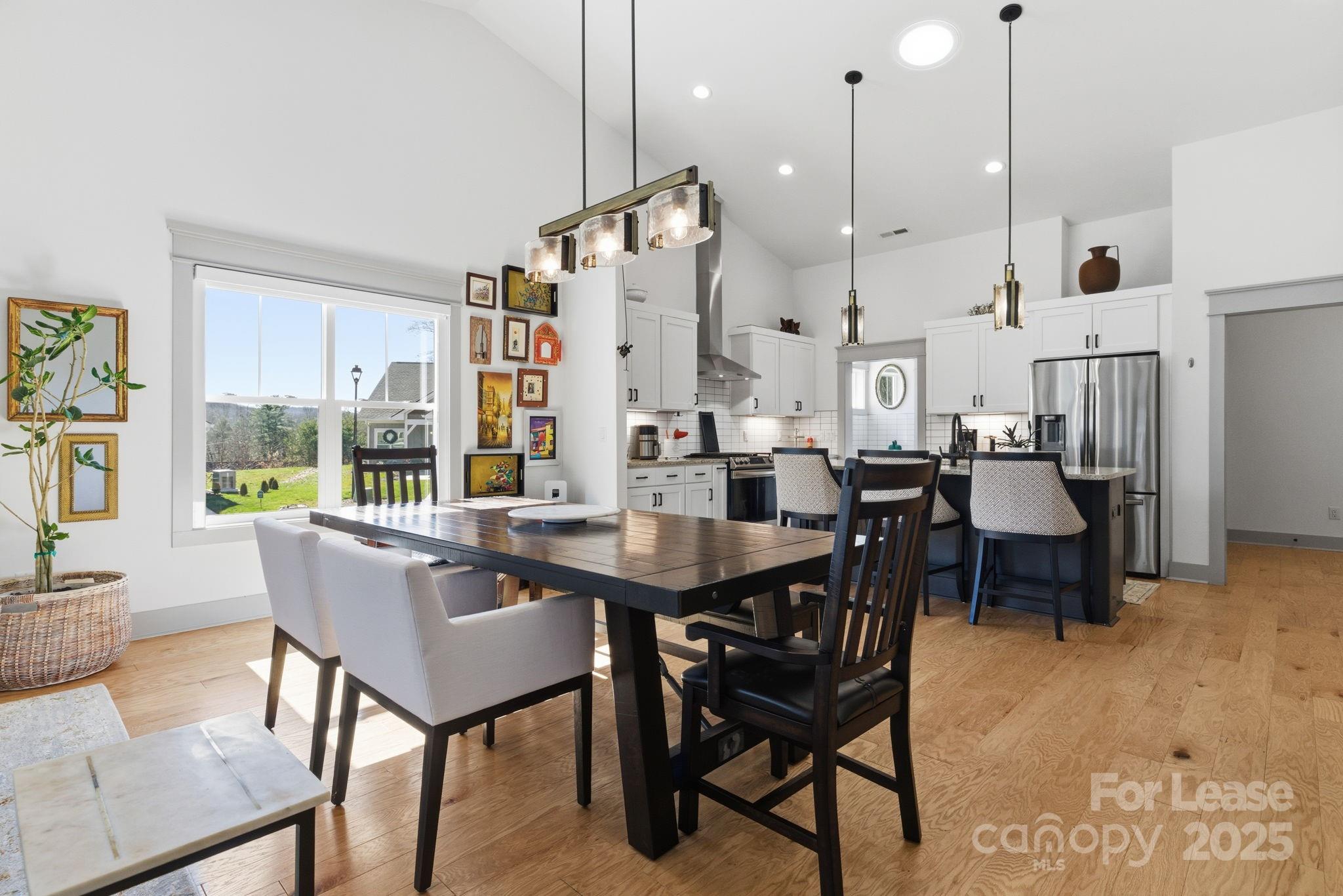 46 Cozy Cottage Way Arden, NC 28704 - Photo 15 of 37 a dining room with furniture a chandelier and wooden floor