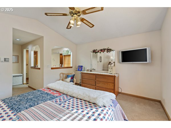 261 Southwest Nancy Circle Gresham, OR 97030 - Photo 11 of 25 a bedroom with a bed and a chandelier