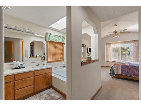 261 Southwest Nancy Circle Gresham, OR 97030 - Photo 12 of 25 a en suite bathroom with a granite countertop sink mirror and vanity
