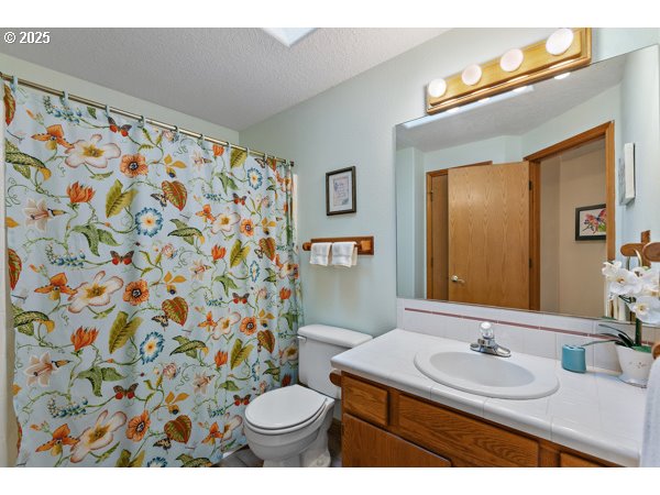 261 Southwest Nancy Circle Gresham, OR 97030 - Photo 14 of 25 a bathroom with a sink and a mirror