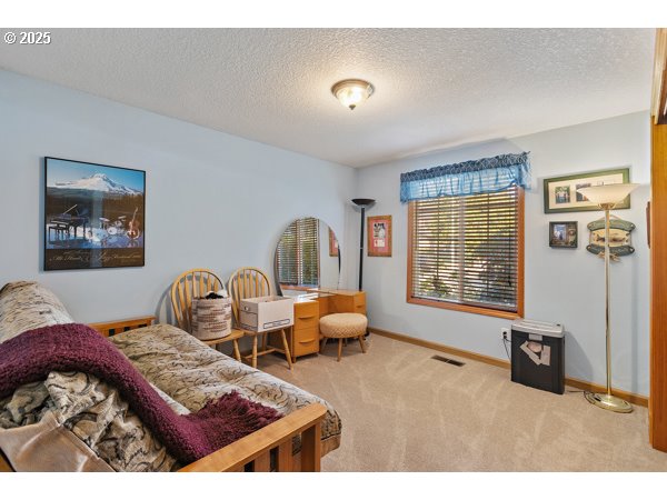 261 Southwest Nancy Circle Gresham, OR 97030 - Photo 16 of 25 a bedroom with furniture and a window
