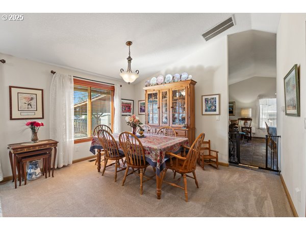 261 Southwest Nancy Circle Gresham, OR 97030 - Photo 6 of 25 a view of a dining room with furniture and chandelier