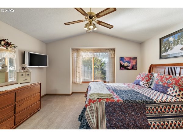 261 Southwest Nancy Circle Gresham, OR 97030 - Photo 9 of 25 a bedroom with a bed and a flat screen tv