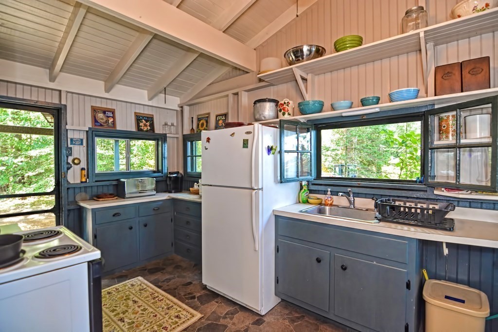 192 Red Gable Road East Brookfield, MA 01515 - Photo 11 of 42 a kitchen with refrigerator cabinets and wooden floor