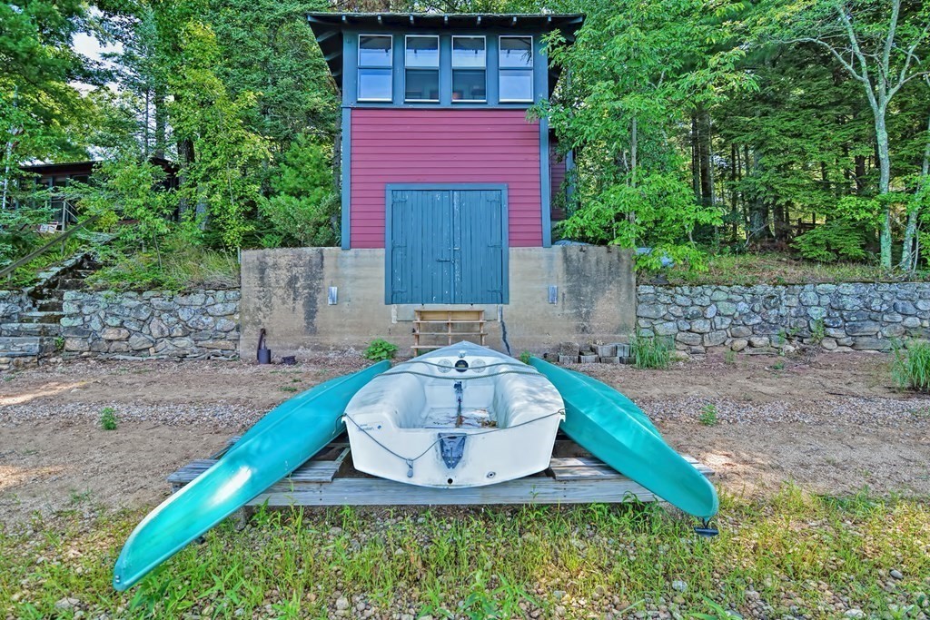 192 Red Gable Road East Brookfield, MA 01515 - Photo 8 of 42 a view of a wooden house with a yard