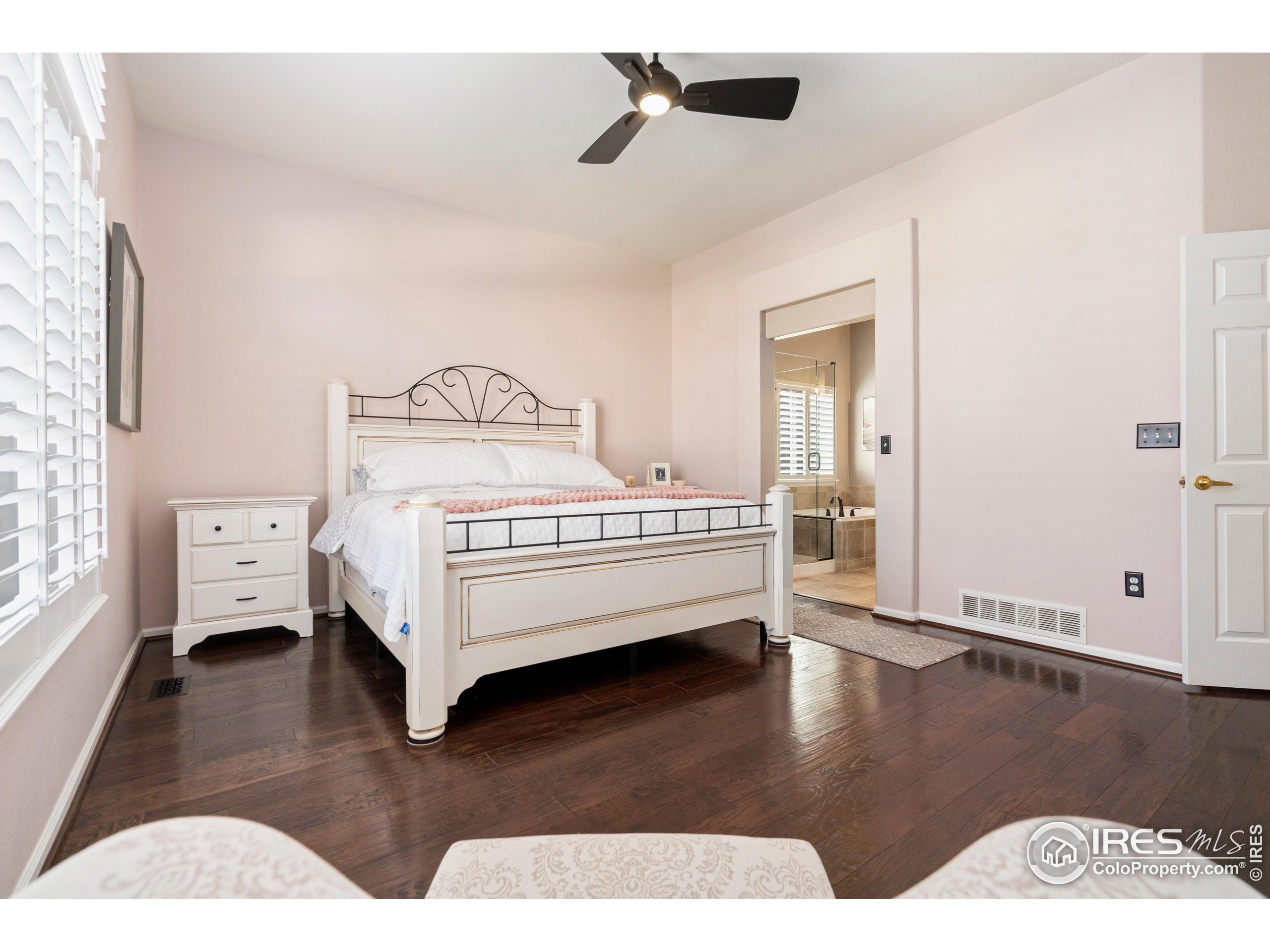 6685 Sage Avenue Firestone, CO 80504 - Photo 15 of 22 a bedroom with a bed and wooden floor
