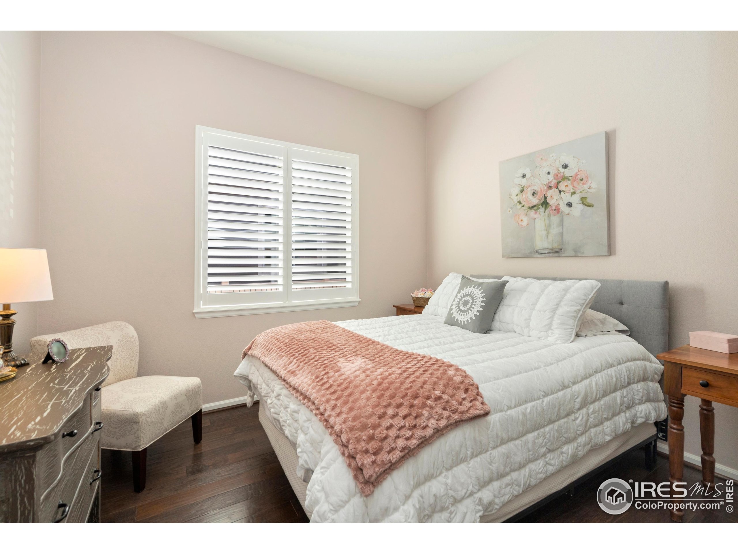 6685 Sage Avenue Firestone, CO 80504 - Photo 18 of 22 a bedroom with a bed and a table