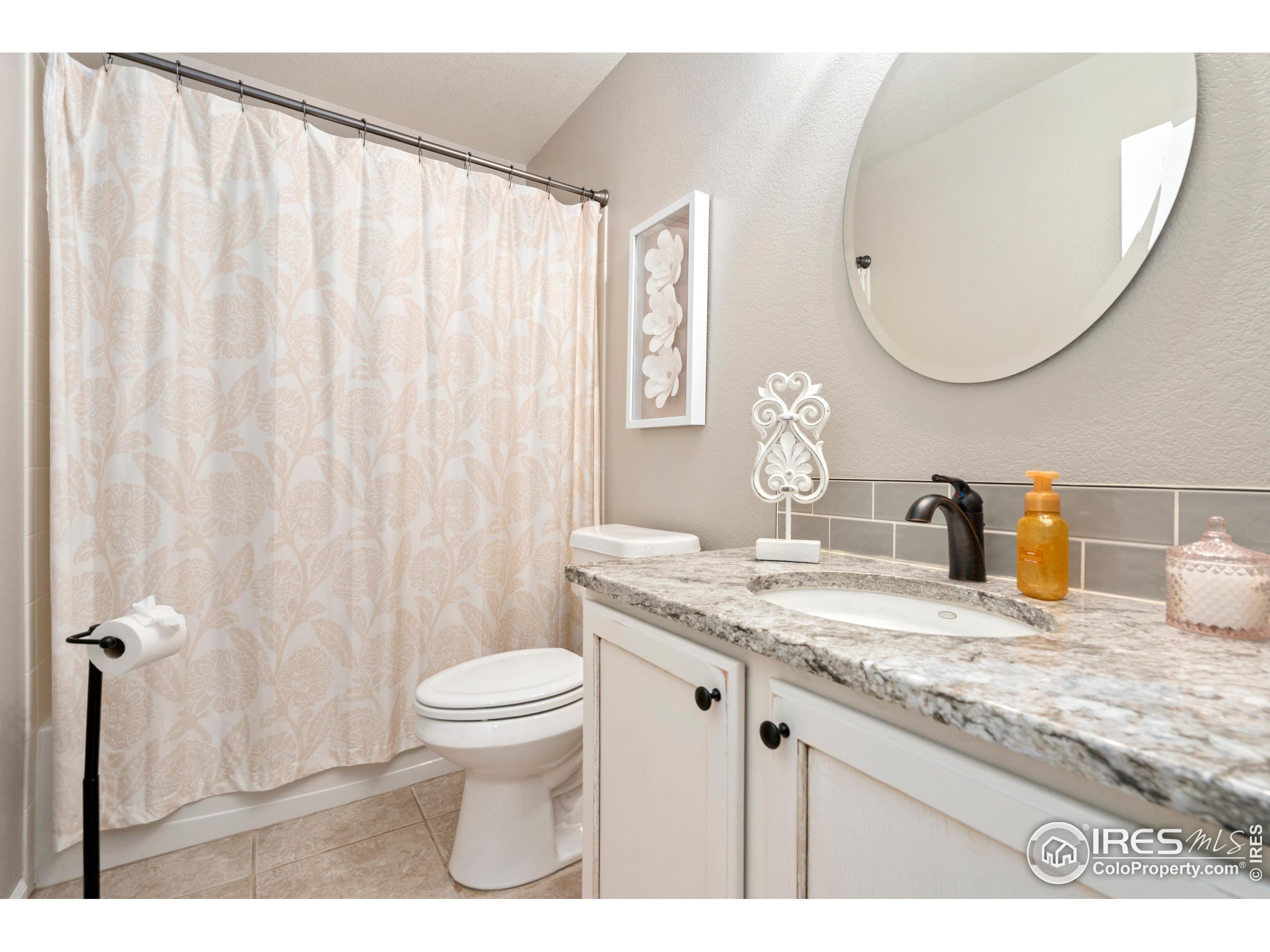 6685 Sage Avenue Firestone, CO 80504 - Photo 19 of 22 a bathroom with a granite countertop sink a toilet and a mirror