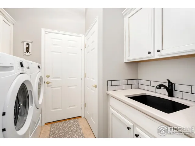 a utility room with sink dryer and washer