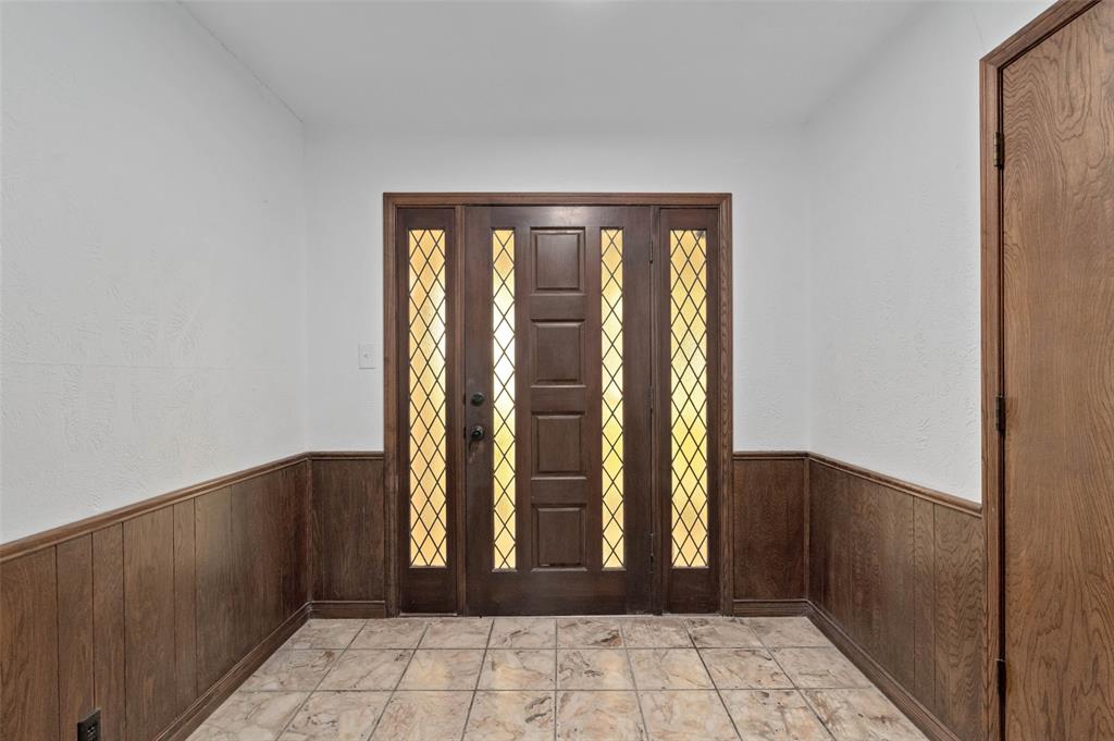 301 East 6th Street Krum, TX 76249 - Photo 6 of 29 Entry way with patterned flooring and decorative front door.