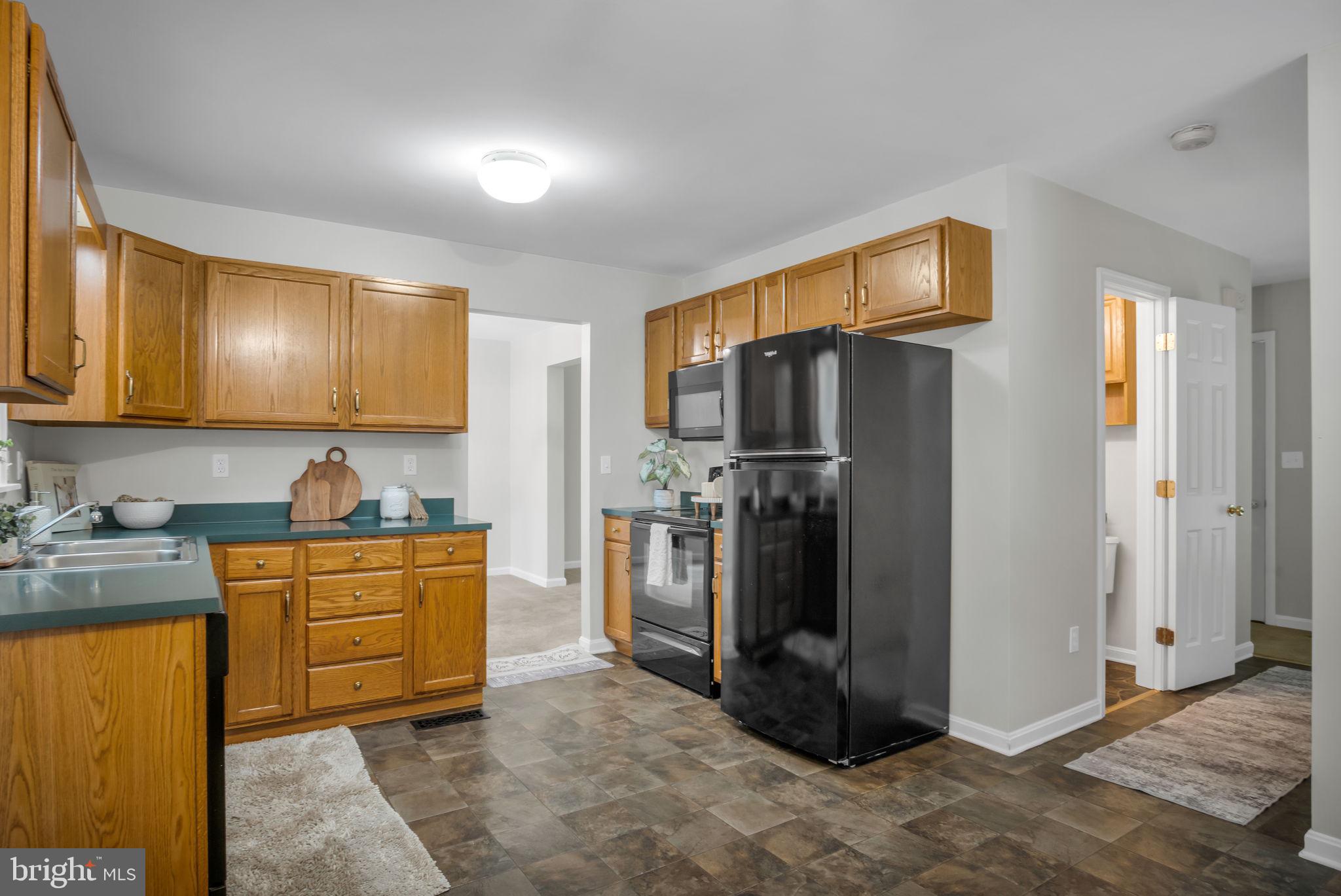 1866 Copenhaffer Road Dover, PA 17315 - Photo 8 of 30 a kitchen with stainless steel appliances granite countertop a refrigerator a stove and a sink