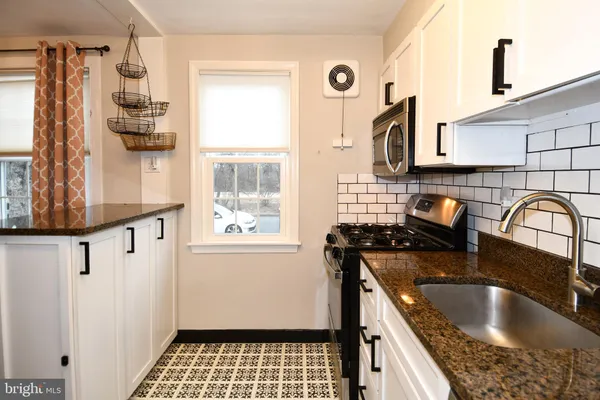 a kitchen with stainless steel appliances a stove a microwave and a refrigerator