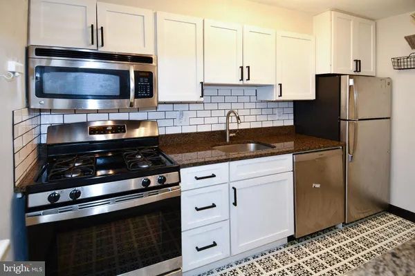 a kitchen with a sink and a refrigerator