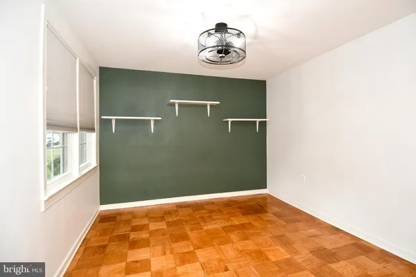 a view of a room with wooden floor and windows