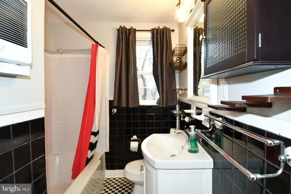 a bathroom with a sink a toilet and mirror