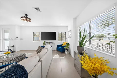 a bedroom with furniture and a flat screen tv